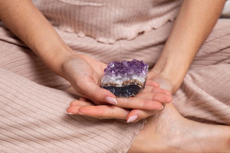 Hands Holding Purple Crystal 23 2149324186 1 768x512 